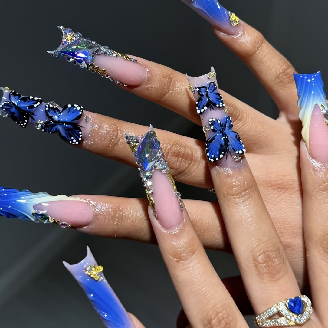 Blue sculptural butterfly press-on nails worn on hand